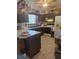 Galley kitchen with dark wood cabinets and white appliances at 2421 Silver Palm Dr, Edgewater, FL 32141