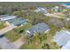 An aerial view of a house with a screened porch and palm trees in a residential neighborhood at 258 Navajo Dr, Oak Hill, FL 32759