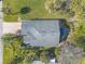 Overhead view of a single-story house with a dark gray roof and landscaping at 258 Navajo Dr, Oak Hill, FL 32759