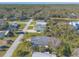 Aerial view showcasing a single-Gathering home with a green roof and palm trees at 258 Navajo Dr, Oak Hill, FL 32759