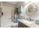 Bathroom with single vanity, tub and decorative mirror at 258 Navajo Dr, Oak Hill, FL 32759