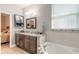 Bathroom with double vanity and a bathtub at 258 Navajo Dr, Oak Hill, FL 32759