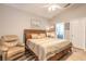 Spacious main bedroom with a king-size bed and sitting area at 258 Navajo Dr, Oak Hill, FL 32759