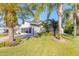 Single-story home with a screened garage and lush landscaping at 258 Navajo Dr, Oak Hill, FL 32759