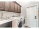 Laundry room with washer, dryer, and utility sink at 258 Navajo Dr, Oak Hill, FL 32759