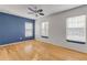 Bright bedroom with hardwood floors and blue accent wall at 2707 Atlantis Dr, New Smyrna Beach, FL 32168