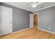 Gray-walled bedroom with hardwood floors and ceiling fan at 2707 Atlantis Dr, New Smyrna Beach, FL 32168