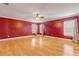 Large bedroom with hardwood floors and red walls at 2707 Atlantis Dr, New Smyrna Beach, FL 32168