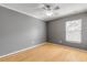 Gray bedroom with wood floors and a window with blinds at 2707 Atlantis Dr, New Smyrna Beach, FL 32168