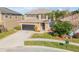 Two-story house with a dark brown garage door and manicured lawn at 2707 Atlantis Dr, New Smyrna Beach, FL 32168