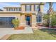 Two-story house with dark brown door and shutters, and landscaping at 2707 Atlantis Dr, New Smyrna Beach, FL 32168