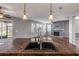 Kitchen island with double sink overlooking living room at 2707 Atlantis Dr, New Smyrna Beach, FL 32168