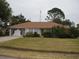 Single-story house with brown roof and white walls, featuring a spacious yard at 2715 Banyan Dr, Edgewater, FL 32141