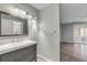 Clean bathroom with modern vanity and view into living area at 28 Lake Fairgreen Cir, New Smyrna Beach, FL 32168