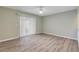 Spacious bedroom featuring wood-look floors and sliding door access at 28 Lake Fairgreen Cir, New Smyrna Beach, FL 32168