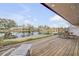 Wooden deck overlooking a tranquil lake, perfect for relaxing at 28 Lake Fairgreen Cir, New Smyrna Beach, FL 32168