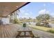 Wooden deck with picnic table overlooking a calm lake at 28 Lake Fairgreen Cir, New Smyrna Beach, FL 32168