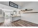 Modern kitchen with white cabinetry, breakfast bar, and gray vinyl flooring at 28 Lake Fairgreen Cir, New Smyrna Beach, FL 32168