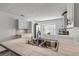 Modern white kitchen with stainless steel appliances and a large sink at 28 Lake Fairgreen Cir, New Smyrna Beach, FL 32168