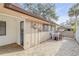 Back patio with brick pavers, access door, and exterior AC unit at 28 Lake Fairgreen Cir, New Smyrna Beach, FL 32168