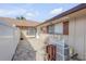 Side patio with brick pavers, white fence, and exterior AC unit at 28 Lake Fairgreen Cir, New Smyrna Beach, FL 32168