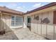 Side patio with brick pavers, decorative fish art, and access door at 28 Lake Fairgreen Cir, New Smyrna Beach, FL 32168