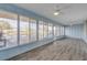 Sunroom with light blue walls and water views at 28 Lake Fairgreen Cir, New Smyrna Beach, FL 32168