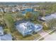 An aerial view showcasing a light teal house with a metal roof and a pool at 2817 Bay Side Dr, New Smyrna Beach, FL 32168