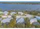 Aerial view of waterfront homes with metal roofs, showcasing a peaceful community at 2817 Bay Side Dr, New Smyrna Beach, FL 32168