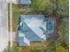 Top-down view of single-Gathering home with metal roof and screened pool at 2817 Bay Side Dr, New Smyrna Beach, FL 32168