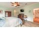 Primary bedroom with king bed, dresser and TV at 2817 Bay Side Dr, New Smyrna Beach, FL 32168