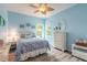 Blue bedroom with a queen bed, dresser, and ceiling fan at 2817 Bay Side Dr, New Smyrna Beach, FL 32168