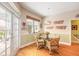 Bright breakfast nook with glass table and wicker chairs, adjacent to kitchen at 2817 Bay Side Dr, New Smyrna Beach, FL 32168