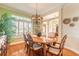 Bright dining room features hardwood floors, an oval wood table, and a chandelier at 2817 Bay Side Dr, New Smyrna Beach, FL 32168