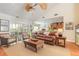 Open living room with hardwood floors, leather sofas and a view of the kitchen at 2817 Bay Side Dr, New Smyrna Beach, FL 32168