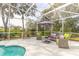 Screened patio with comfy seating surrounding the pool at 2817 Bay Side Dr, New Smyrna Beach, FL 32168