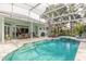 Screened pool and spa with spacious patio and outdoor dining area at 2817 Bay Side Dr, New Smyrna Beach, FL 32168