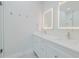 Bright bathroom boasts double sinks, a large mirror, and a walk-in shower at 2870 Isles Way, New Smyrna Beach, FL 32168