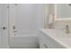 Clean bathroom features a bathtub, white vanity, and a shower at 2870 Isles Way, New Smyrna Beach, FL 32168