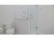 Clean bathroom features a toilet and a shower stall with glass door at 2870 Isles Way, New Smyrna Beach, FL 32168