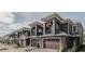 Row of townhouses with gray exterior, brown garage doors, and American flags at 2870 Isles Way, New Smyrna Beach, FL 32168