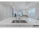 Modern kitchen island with white quartz countertop and stainless steel sink at 2870 Isles Way, New Smyrna Beach, FL 32168