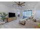 Living room with gray sectional sofa, sliding glass doors, and home office at 2870 Isles Way, New Smyrna Beach, FL 32168