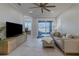 Living room with gray sectional sofa, sliding glass doors, and home office at 2870 Isles Way, New Smyrna Beach, FL 32168