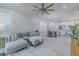 Open living room with gray sectional sofa, wood floors, and kitchen views at 2870 Isles Way, New Smyrna Beach, FL 32168