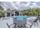 Relaxing community pool with lounge chairs and tables at 2870 Isles Way, New Smyrna Beach, FL 32168