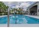 Inviting community pool with lounge chairs and patio at 2870 Isles Way, New Smyrna Beach, FL 32168