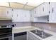 Modern kitchen with stainless steel appliances and white cabinets at 2947 S Atlantic Ave # 1105, Daytona Beach Shores, FL 32118