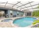 Inviting pool area with covered patio, spa, and grilling station at 3014 Borassus Dr, New Smyrna Beach, FL 32168