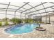 Relaxing screened-in pool and spa with paver deck at 3014 Borassus Dr, New Smyrna Beach, FL 32168